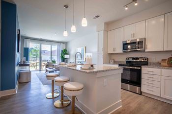 A kitchen with an island and stools
